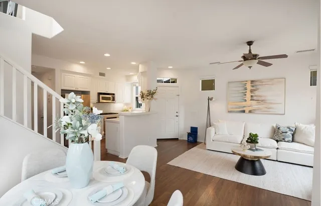 a living room with furniture and view of kitchen
