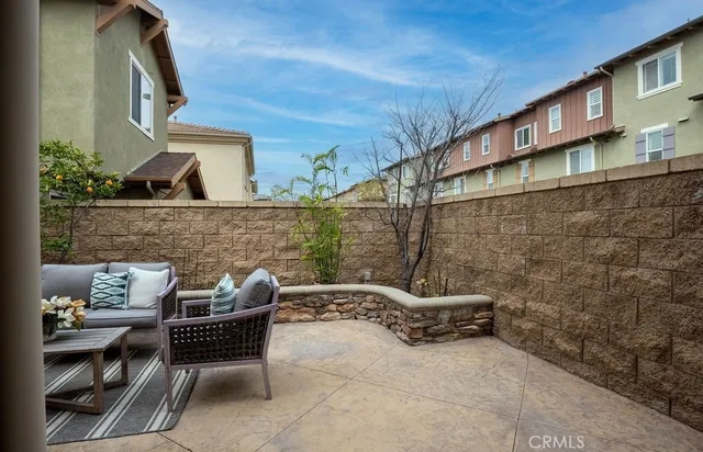 a backyard of a house with outdoor seating
