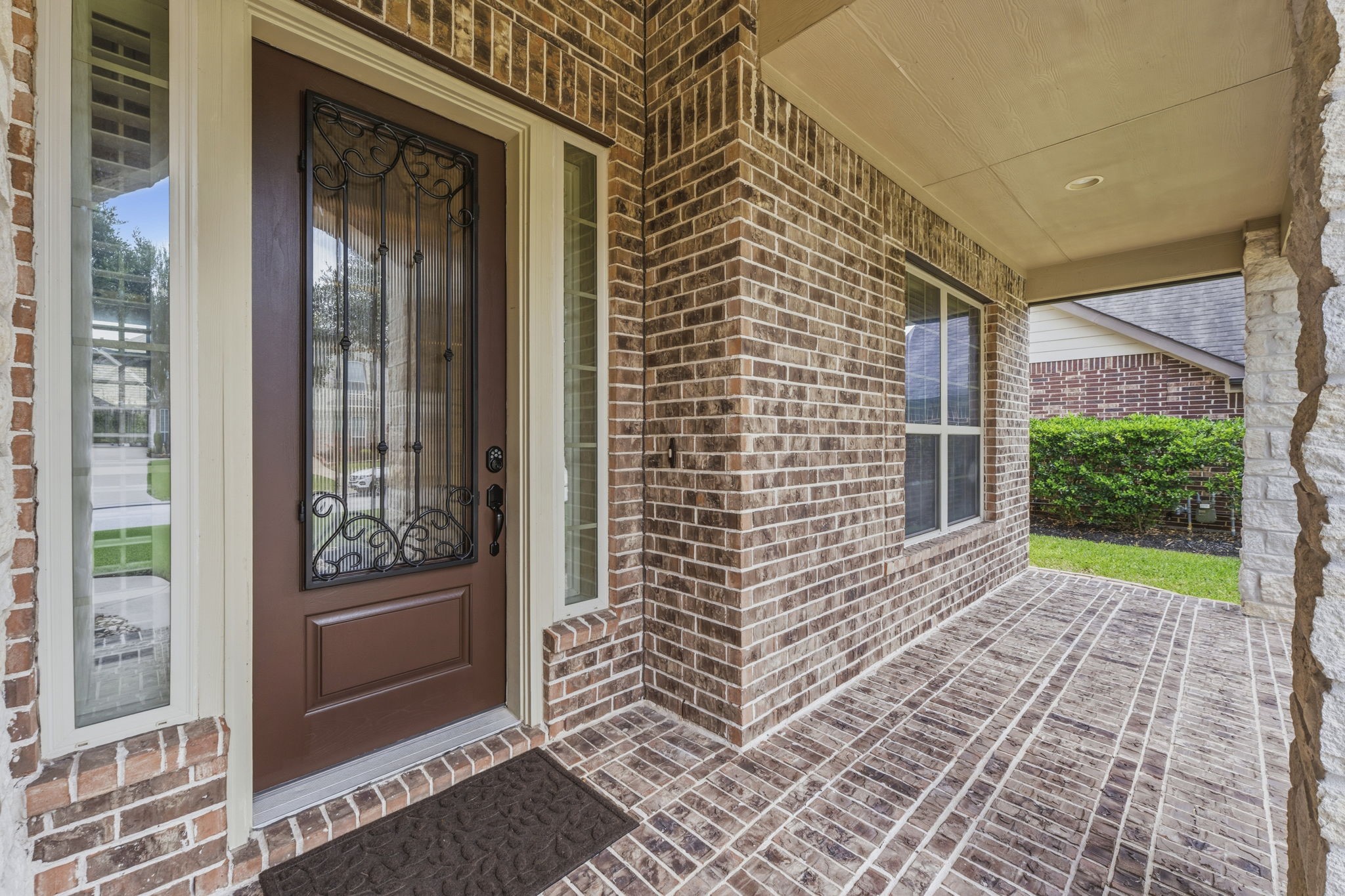 25210 Gaddis Oaks Drive Spring, TX 77389 - Photo 3 of 50 Luxury starts at the gorgeous covered front porch, featuring a stately wood and rippled glass front door flanked by two sidelights with plantation shutters that make a lasting first impression. It's the perfect place for a bistro table and chairs or a porch swing. Inside, this custom home is packed with high-end details and upgrades at every turn, offering a perfect blend of elegance and comfort.
