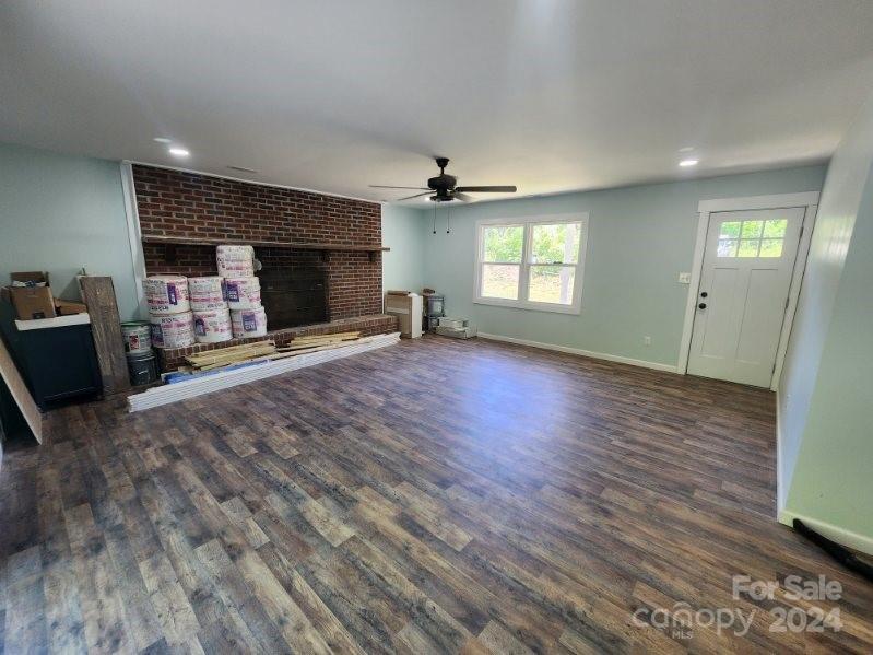 1004 Columbia Road Chester, SC 29706 - Photo 5 of 15 wooden floor in an empty room with a fireplace