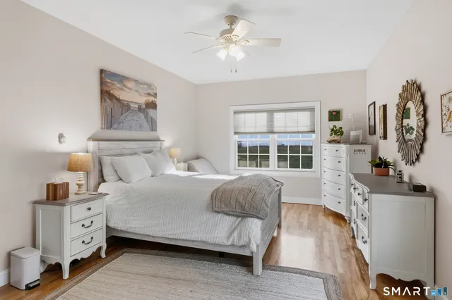 a bedroom with a bed and a large window