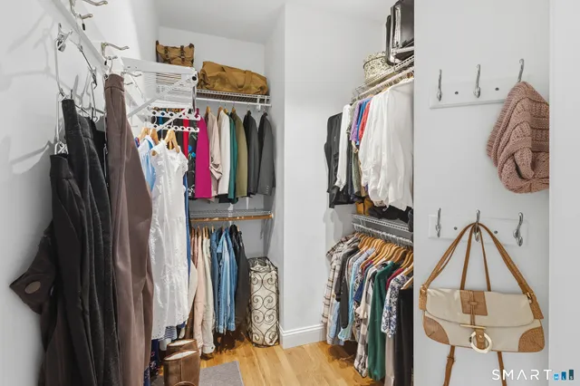 a view of walk in closet with clothes and shoes