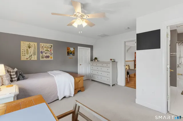 a bedroom with bed and a chandelier