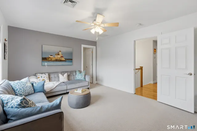 a living room with furniture and a chandelier