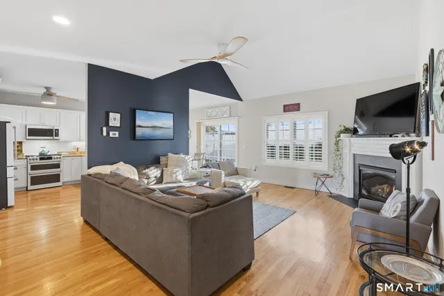 a living room with furniture fireplace and flat screen tv