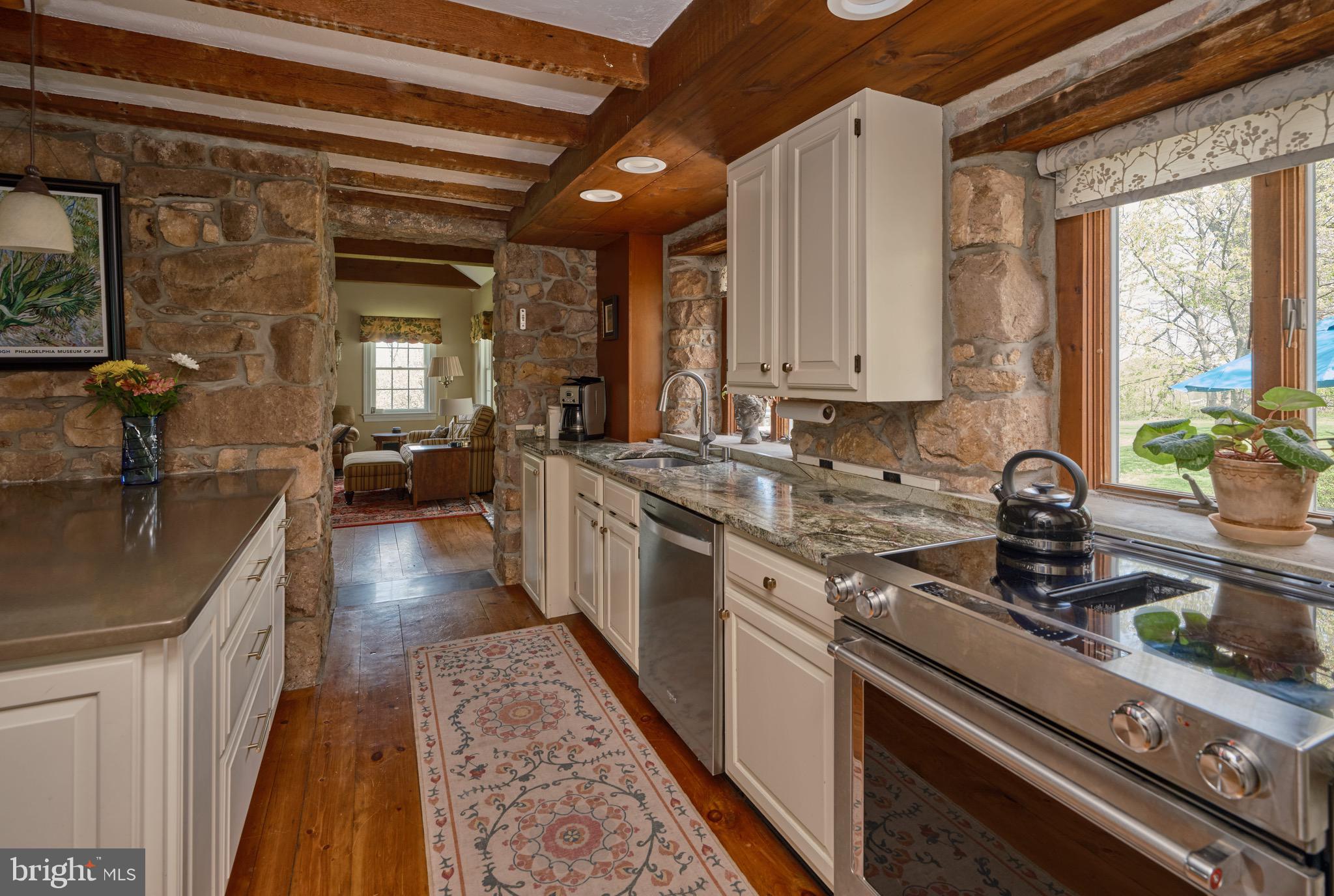 249 Ebelhare Road Pottstown, PA 19465 - Photo 8 of 47 a kitchen with stainless steel appliances granite countertop a sink a stove and a wooden floors