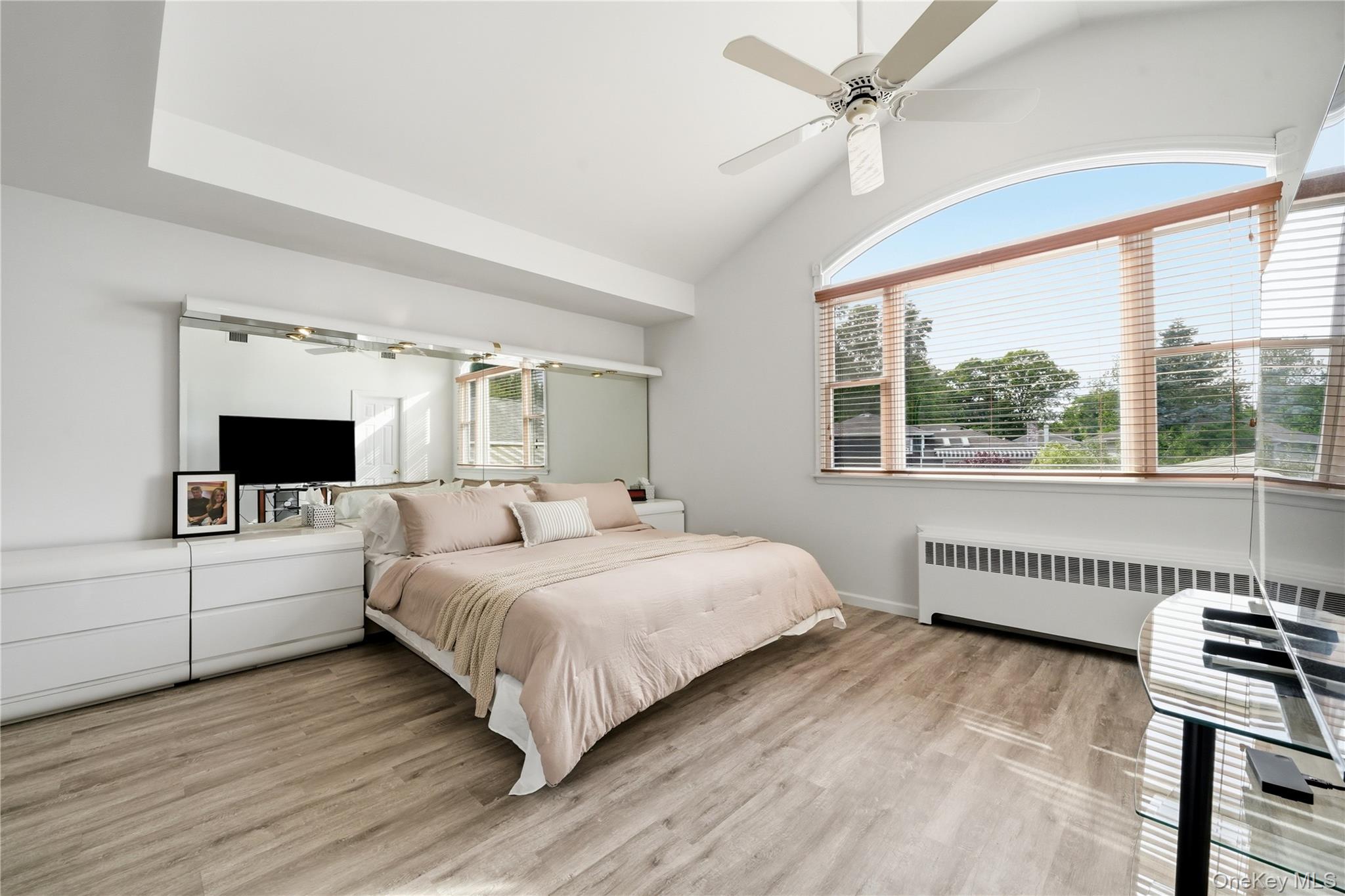 1853 Decatur Avenue Merrick, NY 11566 - Photo 23 of 43 a bedroom with a bed and a flat screen tv