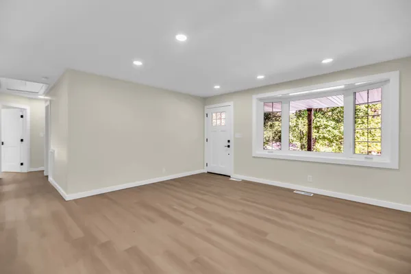 a room with a large window and a bed