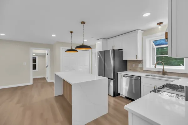 a kitchen with stainless steel appliances a refrigerator sink and stove