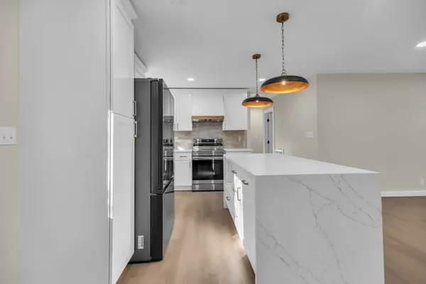 a kitchen with stainless steel appliances a refrigerator sink and stove