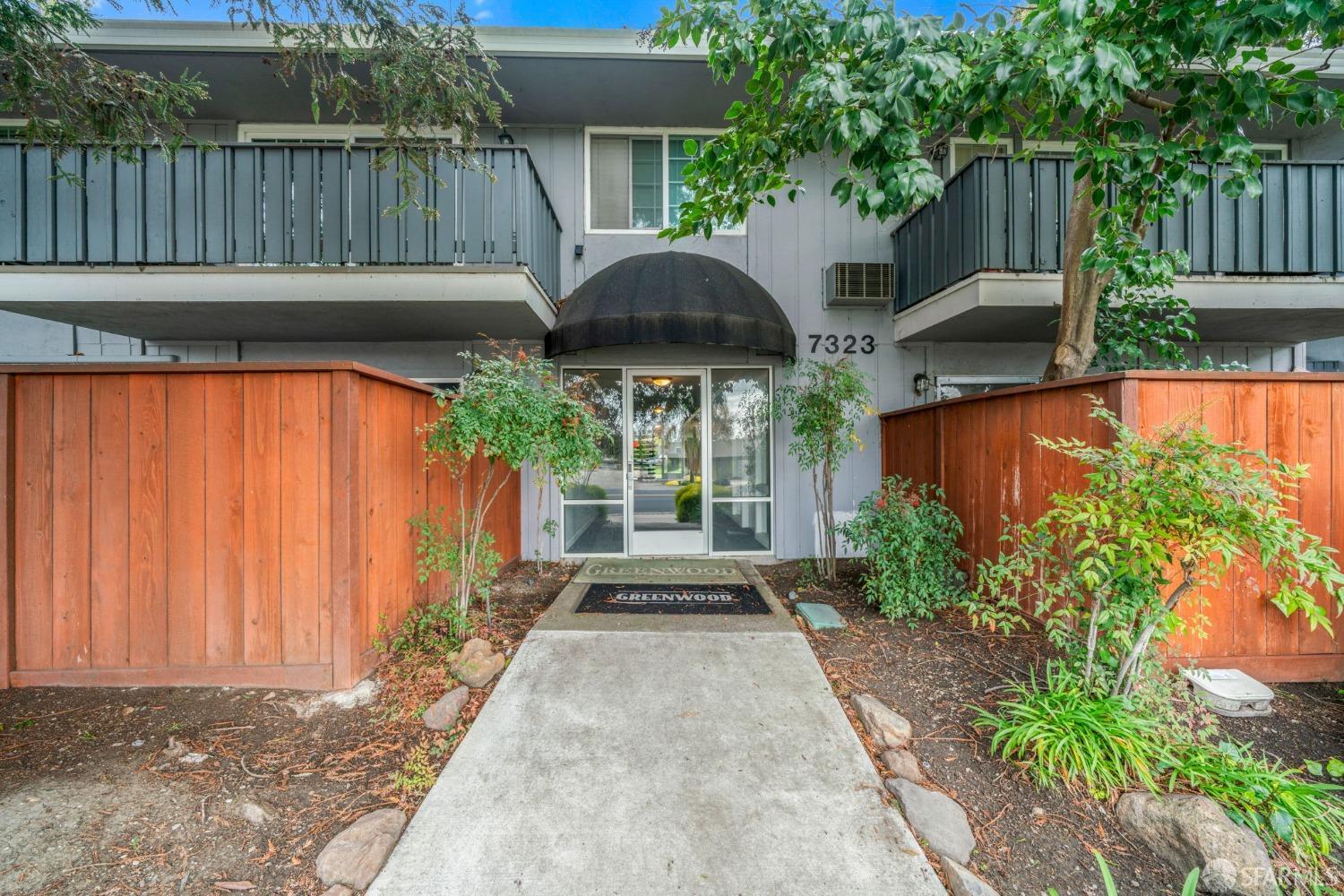 a front view of house with yard and outdoor seating