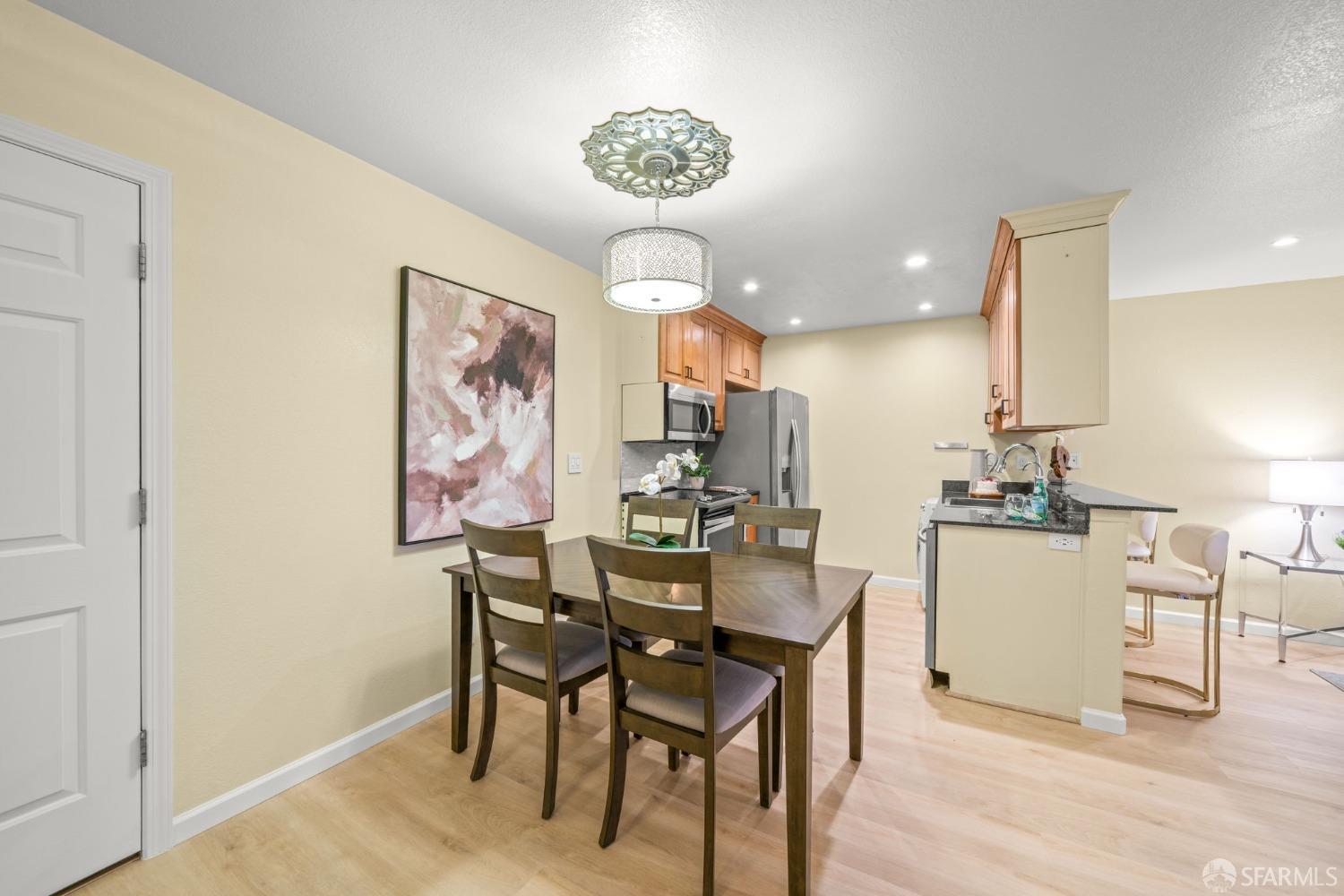 7323 Starward Drive, Unit 8 Dublin, CA 94568 - Photo 2 of 21 a view of a dining room with furniture wooden floor and a chandelier