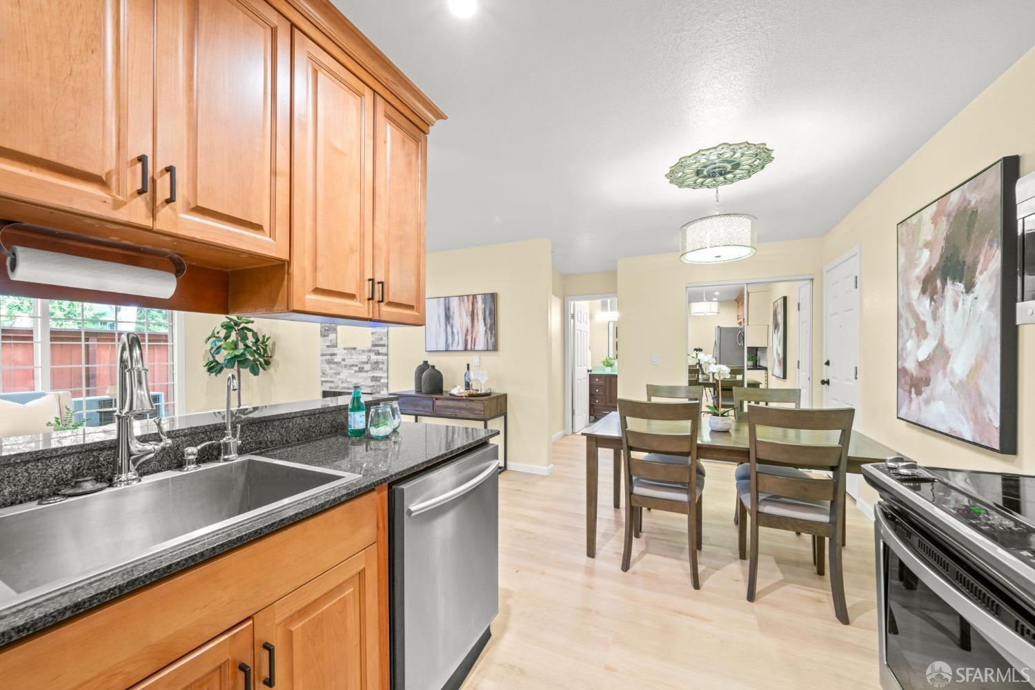 7323 Starward Drive, Unit 8 Dublin, CA 94568 - Photo 7 of 21 a kitchen with stainless steel appliances a sink stove and cabinets