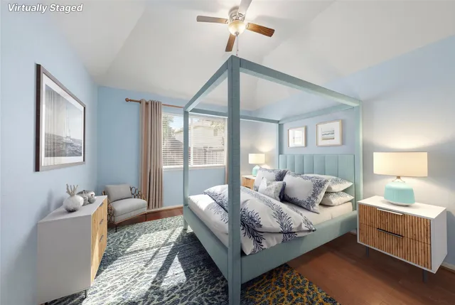 an empty room with wooden floor and ceiling fan