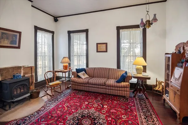 a living room with furniture a lamp and a table