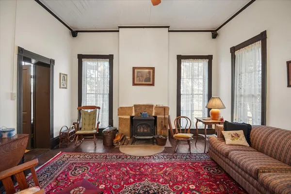 a living room with furniture a couch and two window