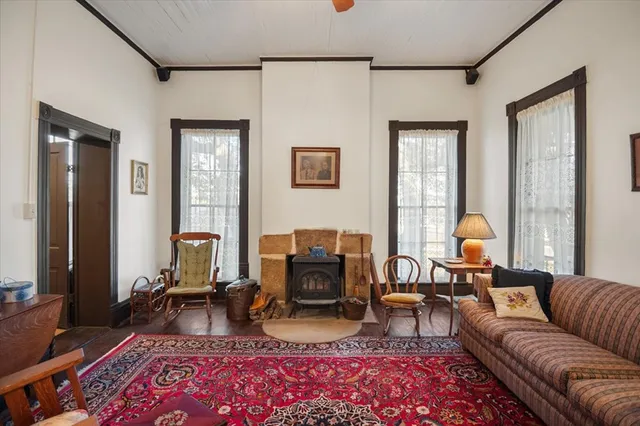 a living room with furniture a couch and two window