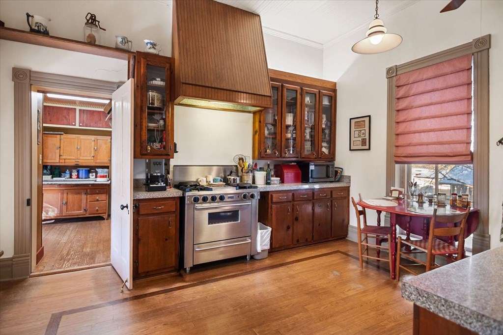 424 Moody Street Mason, TX 76856 - Photo 17 of 49 a kitchen with granite countertop a stove and chairs
