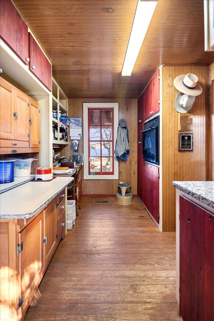 424 Moody Street Mason, TX 76856 - Photo 22 of 49 a large kitchen with stainless steel appliances granite countertop a large stove a sink dishwasher and cabinets with wooden floor