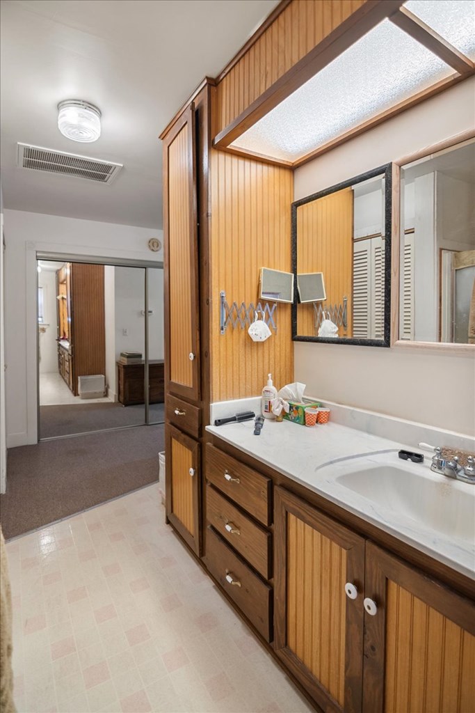 424 Moody Street Mason, TX 76856 - Photo 25 of 49 a bathroom with a double vanity sink and a large mirror