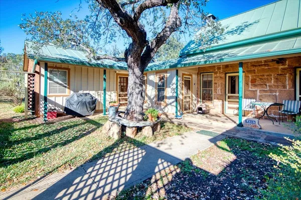 a view of a house with backyard porch and sitting area
