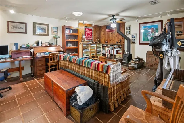 a view of a workspace with furniture and a window