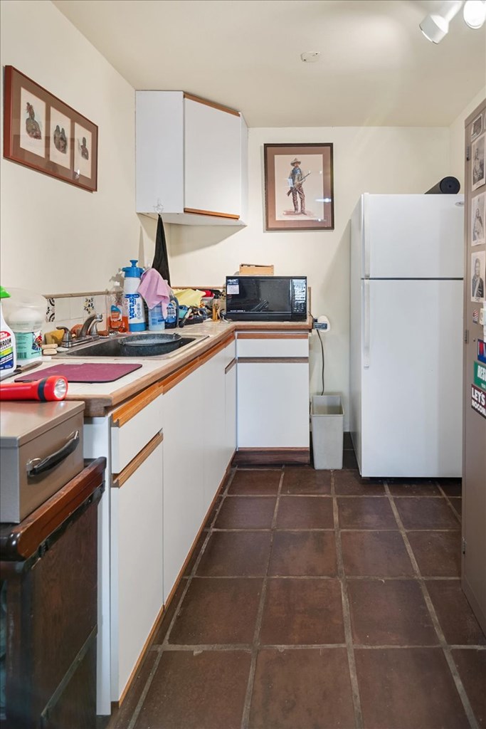 424 Moody Street Mason, TX 76856 - Photo 38 of 49 a kitchen with a refrigerator and a sink
