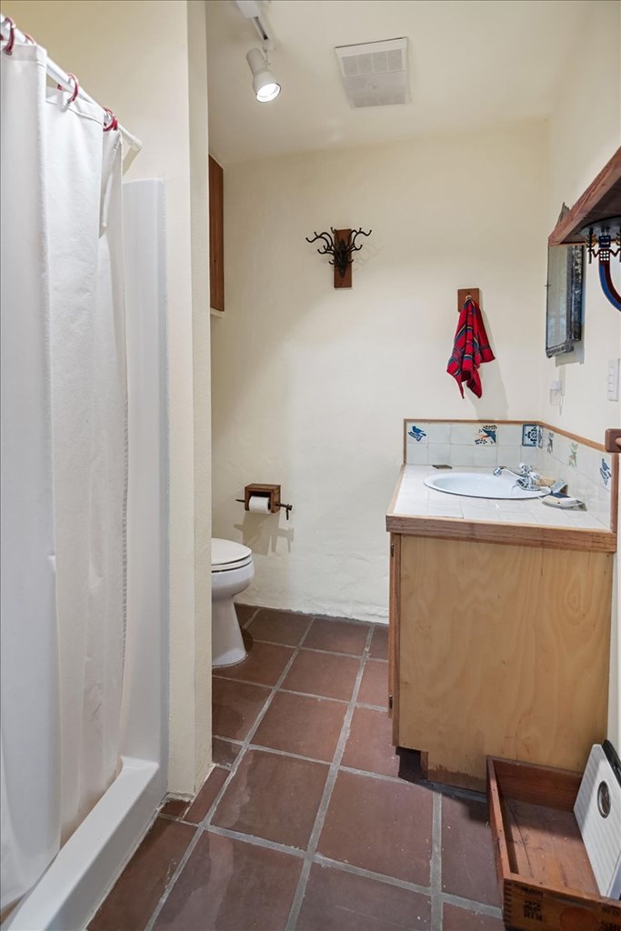 424 Moody Street Mason, TX 76856 - Photo 39 of 49 a bathroom with a sink toilet and shower