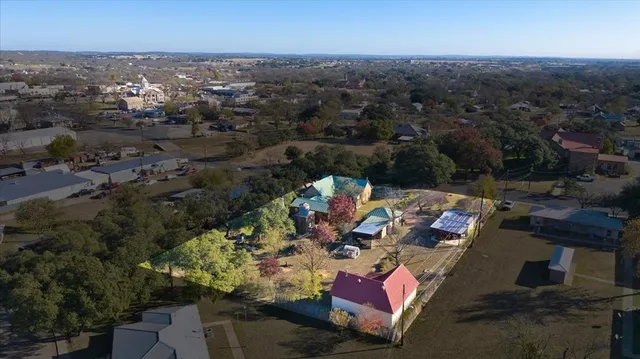 an aerial view of a house with a yard and garden