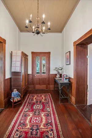 a very nice looking room with wooden floor and furniture
