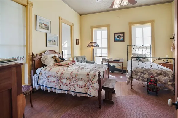 a bedroom with a bed and wooden floor