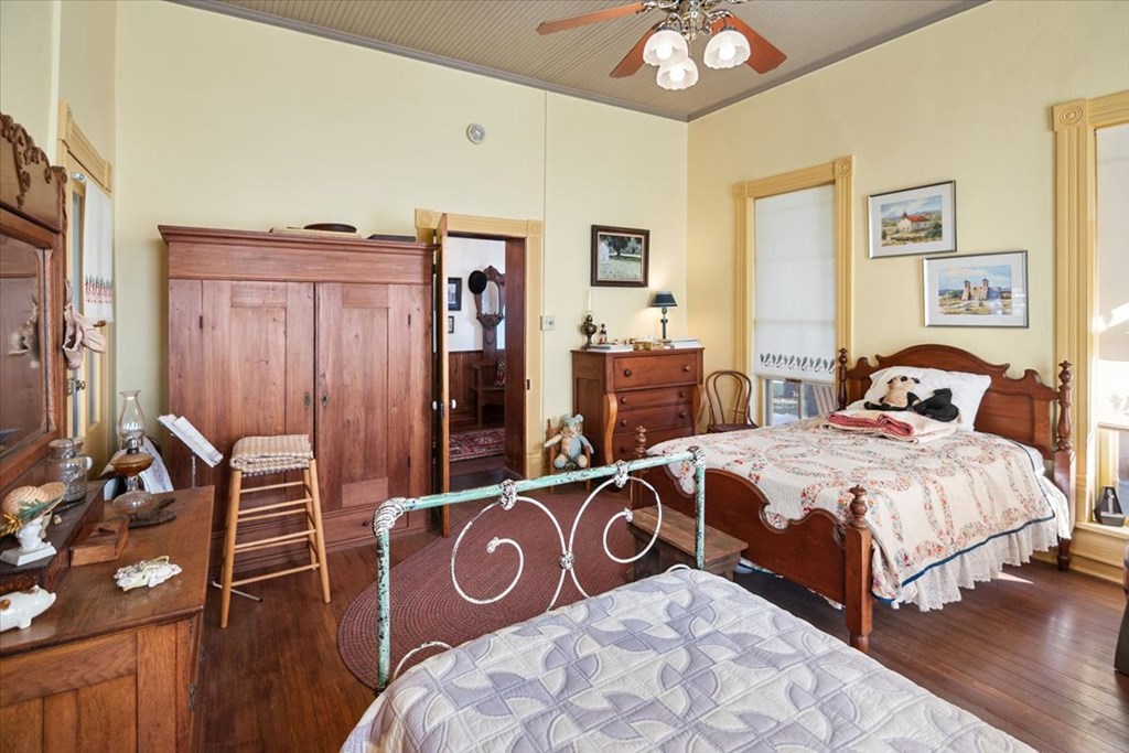 424 Moody Street Mason, TX 76856 - Photo 10 of 49 a bedroom with a bed and wooden floor