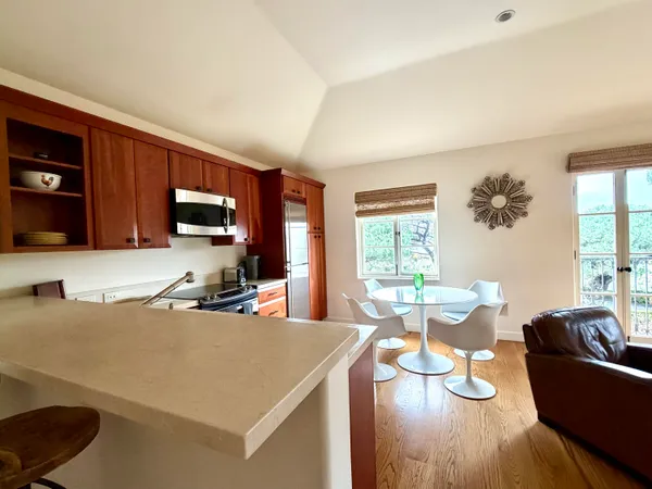 a living room with furniture a flat screen tv and large window