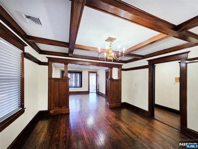 a view of a hallway with wooden floor and stairs