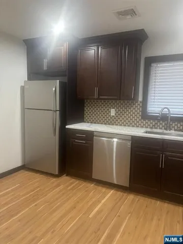 a kitchen with a sink and a refrigerator