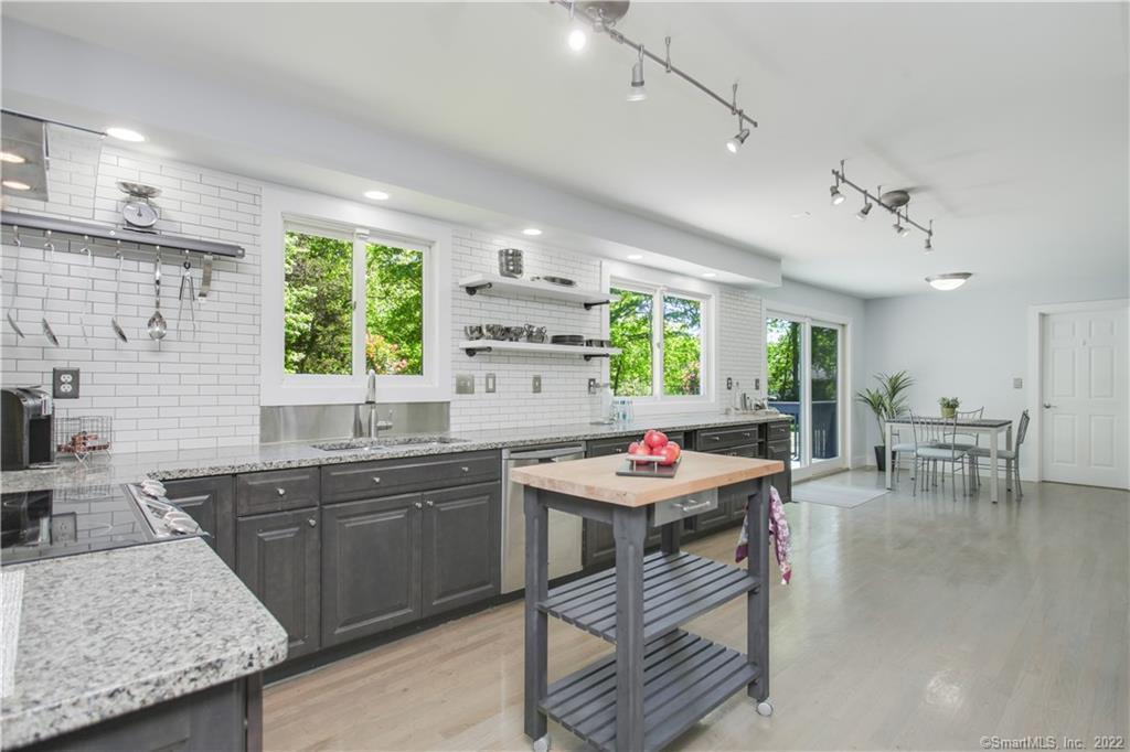 Kitchen with granite counters and subway tile backsplash. Perfect for entertaining!