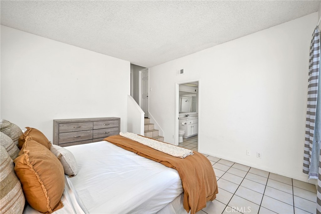 4103 Seashore Drive Newport Beach, CA 92663 - Photo 12 of 62 a bedroom with a bed and painting on the wall