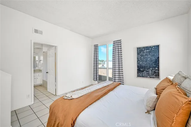 a bedroom with a large bed and a couch