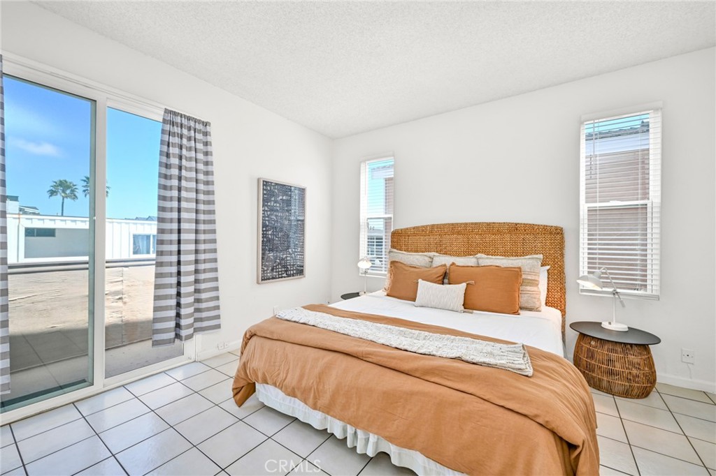 4103 Seashore Drive Newport Beach, CA 92663 - Photo 14 of 62 a bedroom with a large bed and a couch