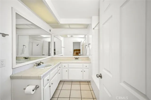 a bedroom with two beds and a lamp