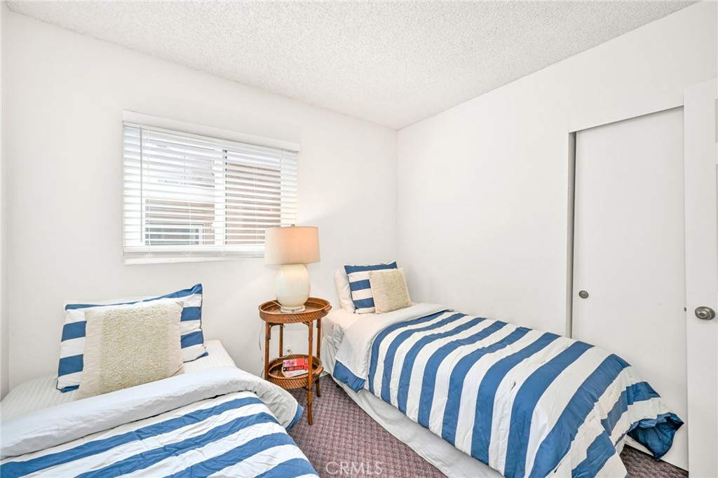 4103 Seashore Drive Newport Beach, CA 92663 - Photo 19 of 62 a bedroom with a bed and a lamp next to a window