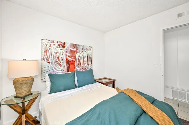 a kitchen with granite countertop a sink stainless steel appliances white cabinets and a window