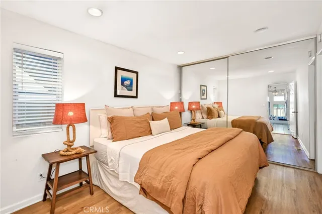 a bedroom with two beds and a potted plant