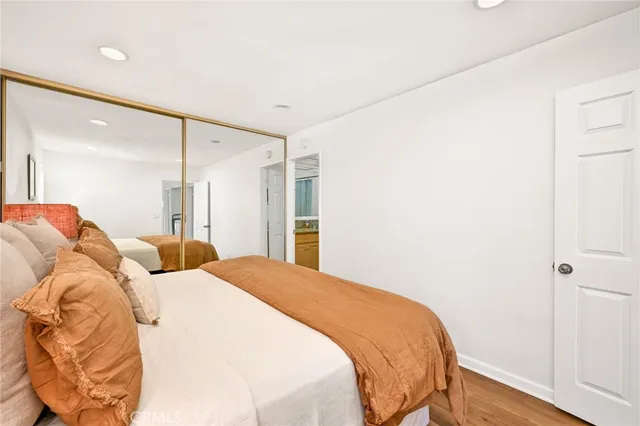 a bed sitting in a bedroom next to a window