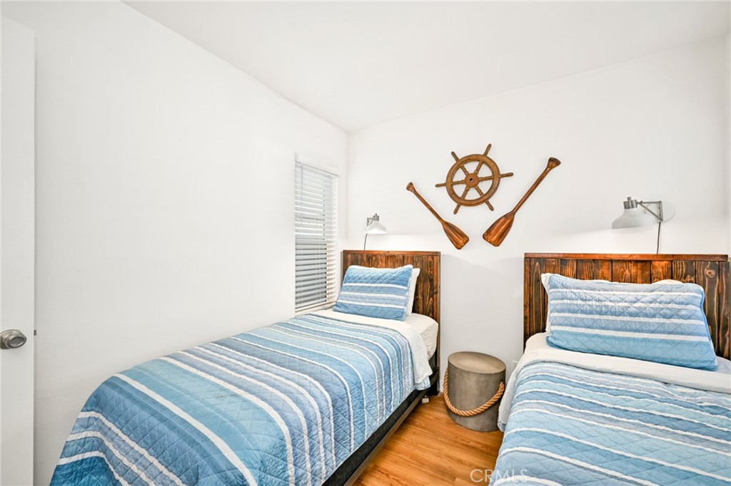 4103 Seashore Drive Newport Beach, CA 92663 - Photo 37 of 62 a bedroom with double bed and a window