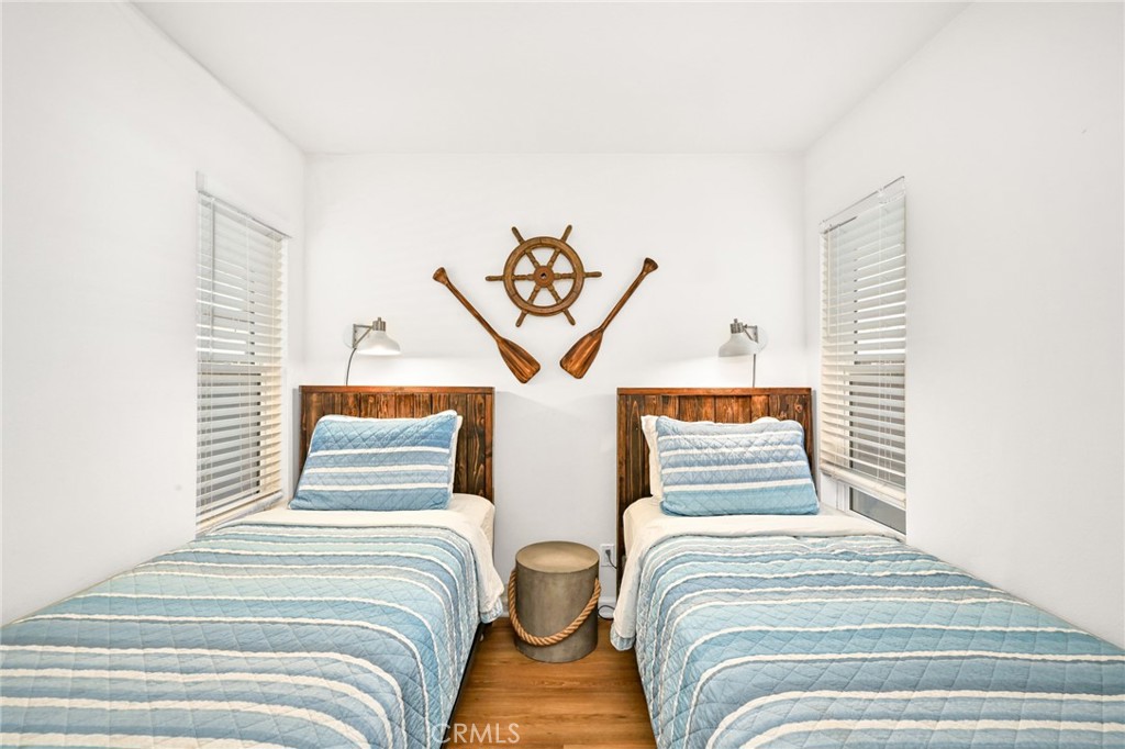 4103 Seashore Drive Newport Beach, CA 92663 - Photo 38 of 62 a bedroom with two beds and a potted plant