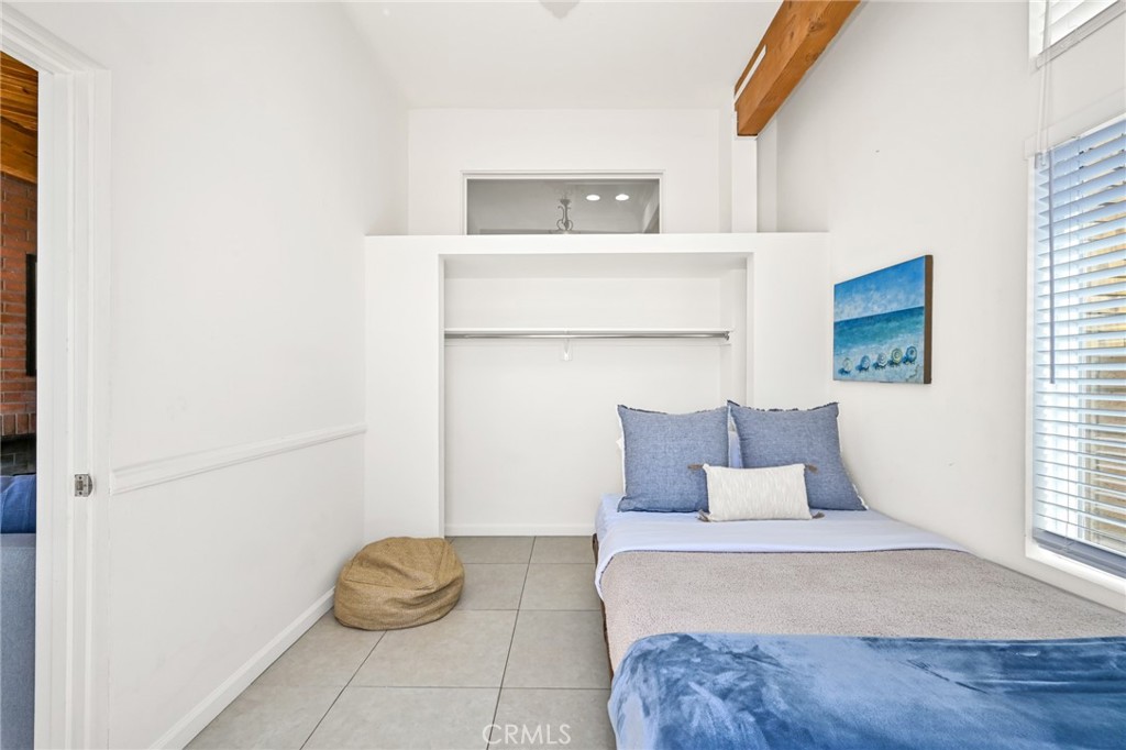 4103 Seashore Drive Newport Beach, CA 92663 - Photo 40 of 62 a bedroom with a bed and window