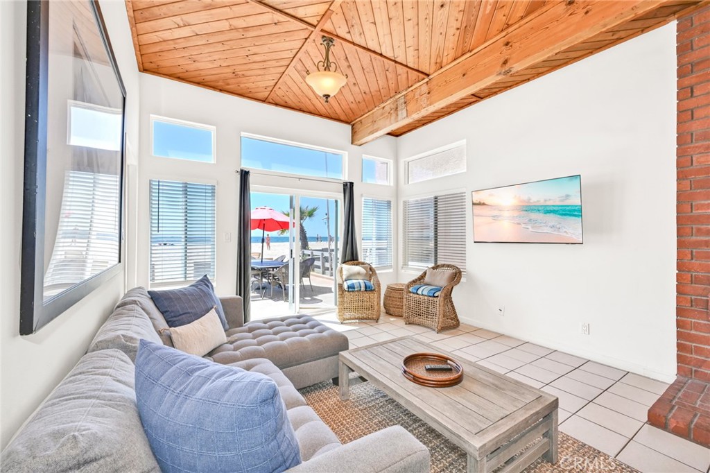 4103 Seashore Drive Newport Beach, CA 92663 - Photo 45 of 62 a living room with furniture and a floor to ceiling window