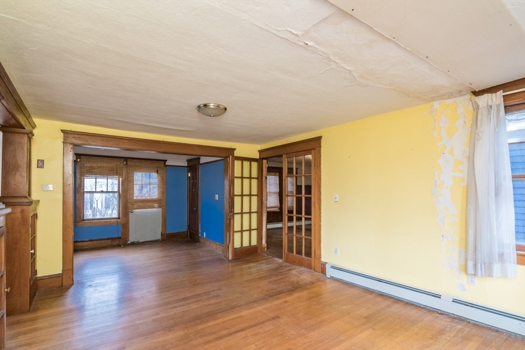 110 Old Amherst Road Sunderland, MA 01375 - Photo 11 of 41 an empty room with wooden floor and windows