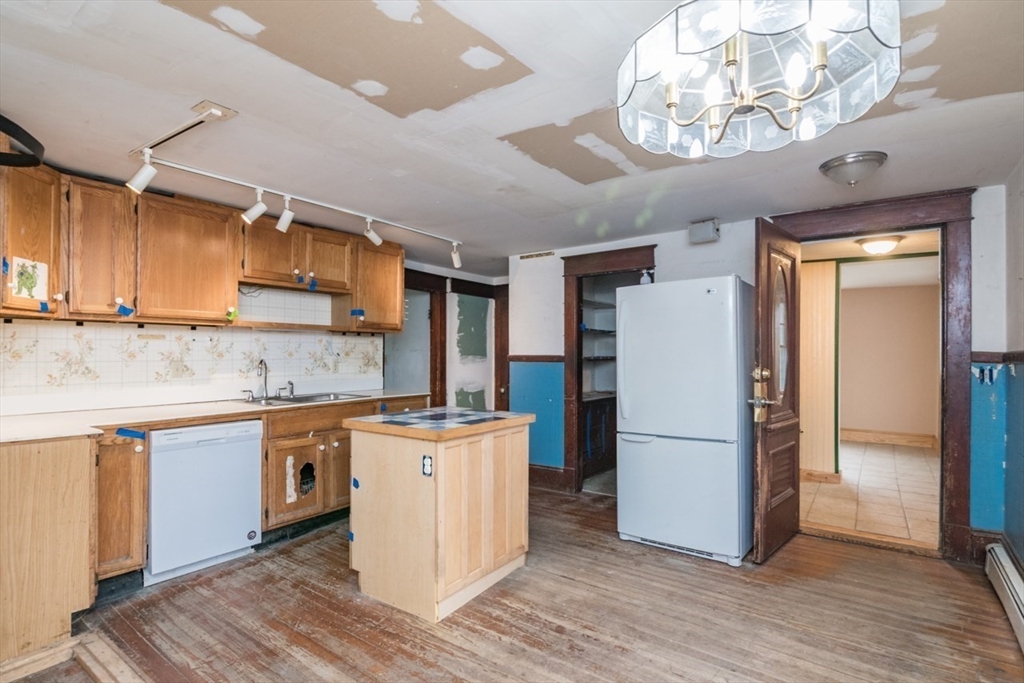 110 Old Amherst Road Sunderland, MA 01375 - Photo 16 of 41 a kitchen with granite countertop a refrigerator a stove a sink and cabinets